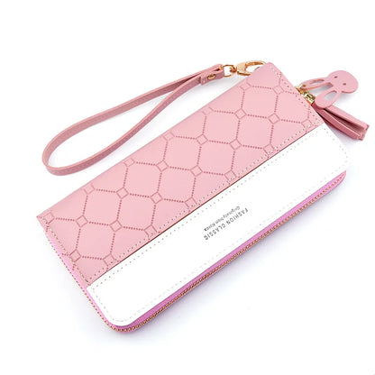 Pink quilted zip around women's long wallet with wrist strap and tassel elegant PU leather clutch front view
