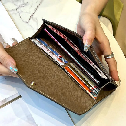 Open genuine leather long wallet showing multiple card slots zip compartment and structured interior design