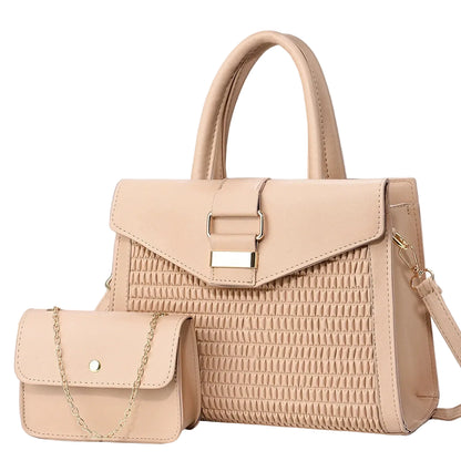 Beige handbag with textured pattern and matching small purse on a gray background