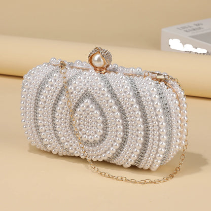 Luminous pearl beaded evening clutch showing structured frame closure and chain strap detail, formal women’s party handbag