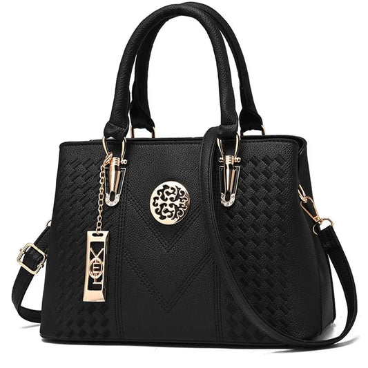 Black structured women’s satchel handbag with gold crest detail and top handles, elegant PU leather tote bag for work and everyday use