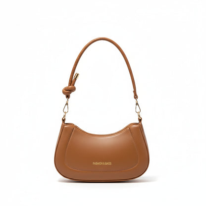 Compact mini crescent handbag showing interior capacity and soft structured silhouette, modern women’s shoulder bag for everyday wear