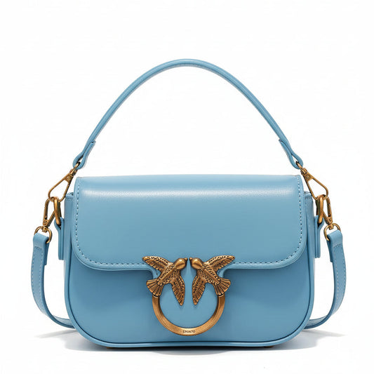 Black mini crossbody handbag with gold emblem clasp and top handle, elegant women’s designer inspired purse