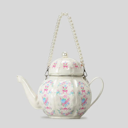 Creative teapot purse showing unique handbag silhouette and chain strap, playful novelty handbag for women