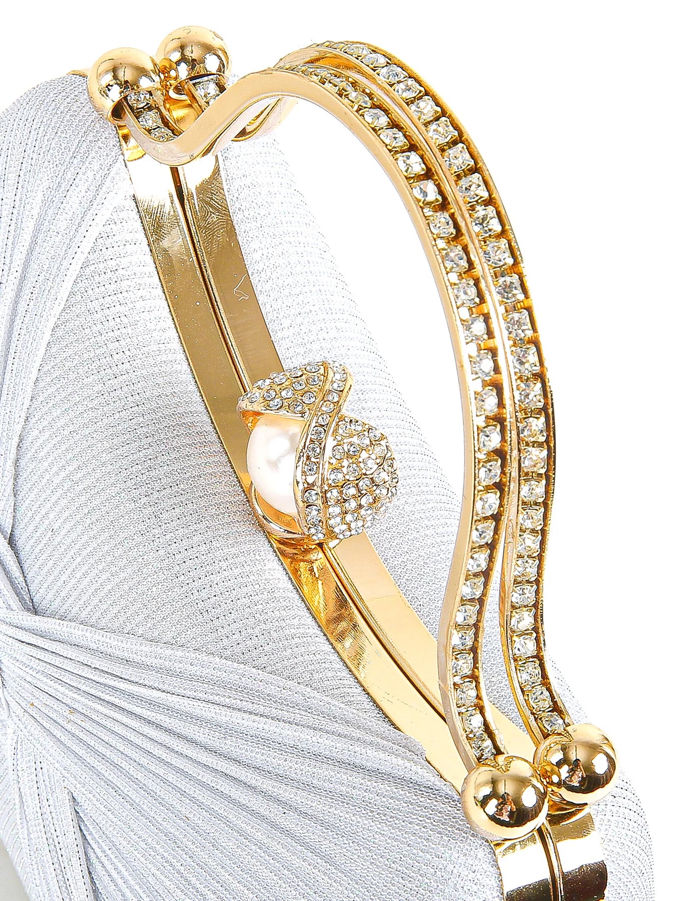 Structured evening clutch with sculptural handle and chain strap detail, luxury women’s party handbag with textured finish